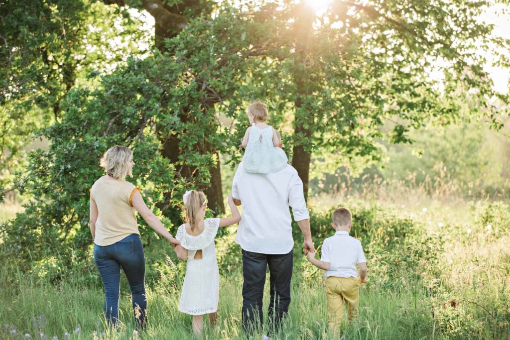 family walking through meadow