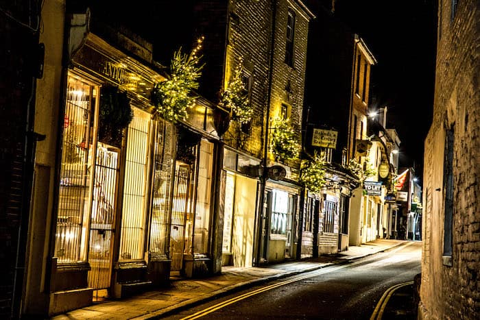 lit christmas trees attached to shops