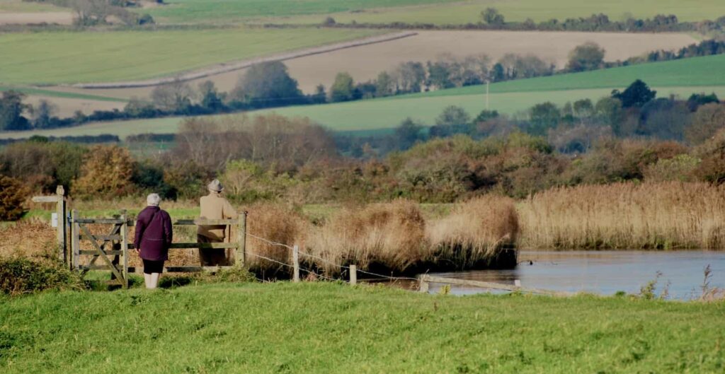 couple walking by river arun