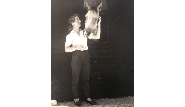 woman standing with horse