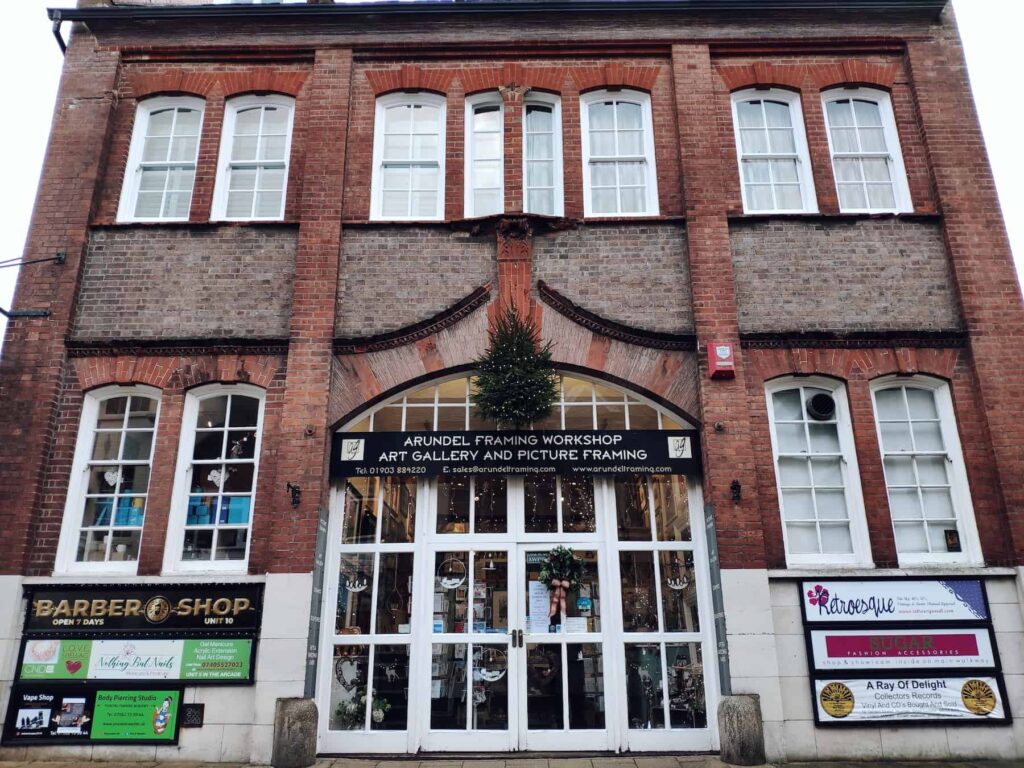 outside of picture framing shop with christmas tree on wall