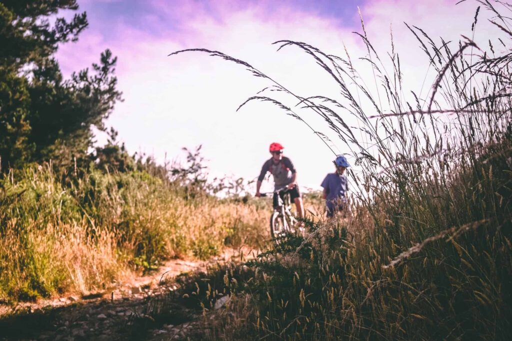 2 people cycling on country path